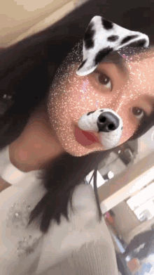 a girl wearing a dalmatian dog mask on her face
