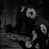 a black and white photo of a person wearing a hoodie with white clouds on it