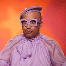 a man wearing glasses and a purple hat is dancing