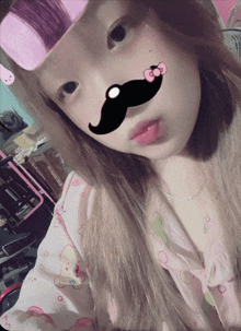 a girl wearing a hello kitty shirt has a mustache on her face
