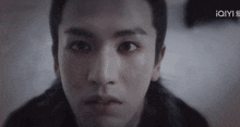 a close up of a man 's face with the iqyi logo visible in the corner
