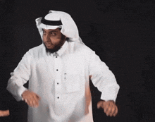 a man wearing a white shirt and a black turban