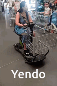 a woman is sitting in a shopping cart with the word yendo written on the bottom
