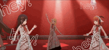 three anime girls are dancing on a stage with the words hey written around them