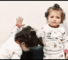a blurry picture of a little girl and a dog with the words '  hahaha ' on the bottom
