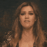 a close up of a woman 's face in a dark room