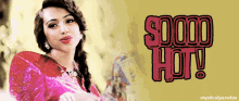 a woman in a pink dress is standing in front of a sign that says so hot