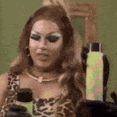 a woman in a leopard print top is holding a bottle of lotion