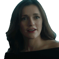 a woman in a black off the shoulder top looks at the camera