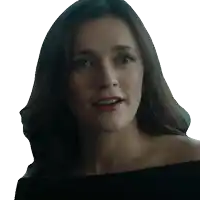 a woman in a black off the shoulder top looks at the camera