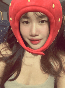 a woman wearing a red hat with yellow dots