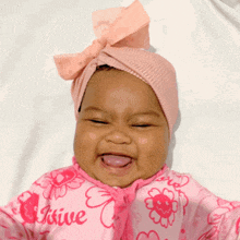 a baby wearing a pink outfit that says " i 'm a kiwie "