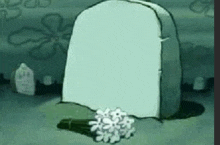 a cartoon drawing of a grave with flowers on it .