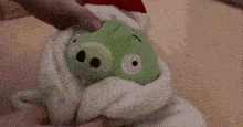 a person is holding a stuffed animal that looks like an octopus