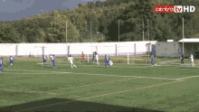 a group of soccer players on a field with a centro tv hd sign above them