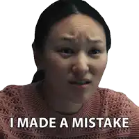 a woman in a pink sweater has the words i made a mistake written on her face