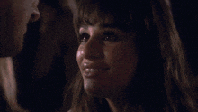 a close up of a woman looking at a man