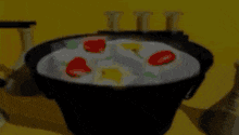 a bowl of eggs and tomatoes on a yellow background