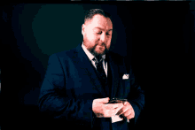 a man in a suit and tie is holding a lighter in his hand