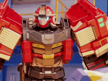 a robot with blue eyes and a red helmet has the letter b on its chest