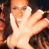 a close up of a woman 's face with a crowd in the background