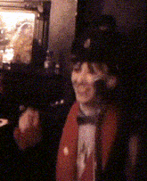 a man wearing a top hat and a red coat