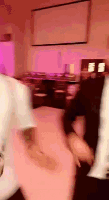 a blurry picture of people dancing in a room