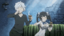 a boy and a girl are sitting on a couch drinking from wooden cups