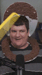 a man is being combed by a yellow comb