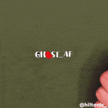 a person 's hand is holding a piece of paper with the word ghost written on it