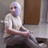 a man with a purple mask on his face sits on the floor with a viggle.ai advertisement above him