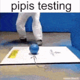 a person is standing next to a blue ball on a box .