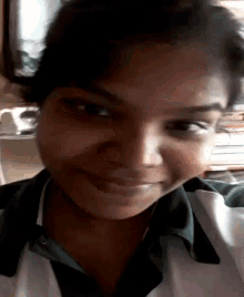 a close up of a woman 's face with a green shirt on