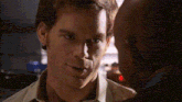 a close up of a man 's face looking at another man .