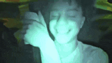 a man is making a funny face with his hands in a blurry picture .