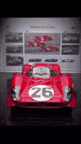 a red race car with the number 26 on the side