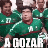 a group of soccer players wearing green jerseys with the number 27 on them