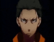 a close up of a person 's face with a serious look on his face .