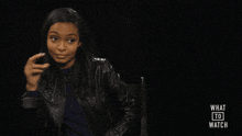 a woman sitting in a chair with the words what to watch on the bottom
