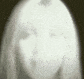 a ghostly image of a woman 's face with a dark background