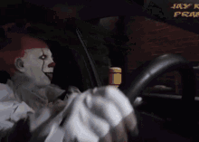 a clown is driving a car in front of a sign that says " jay k prime "