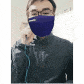 a man wearing a purple face mask with the word purple written on it