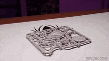 a gif from gifrun.com shows a toy spider