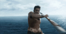 a man is standing in the middle of the ocean