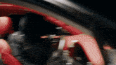 a blurry picture of a red car with a black background
