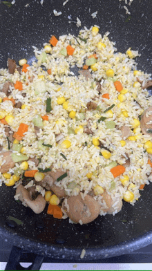 a pan filled with rice and vegetables is being cooked