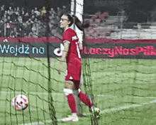a woman in a red jersey with the number 1 on it
