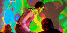 a man is dancing in front of a colorful wall