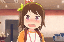 a girl with a green bow in her hair looks surprised and shocked