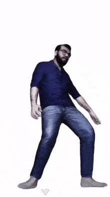 a man with glasses and a beard is squatting with his arms in the air